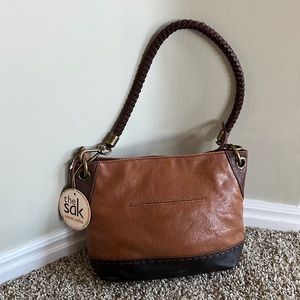 The Sak Genuaine brown Leather handbag purse should bag brand new has pen mark